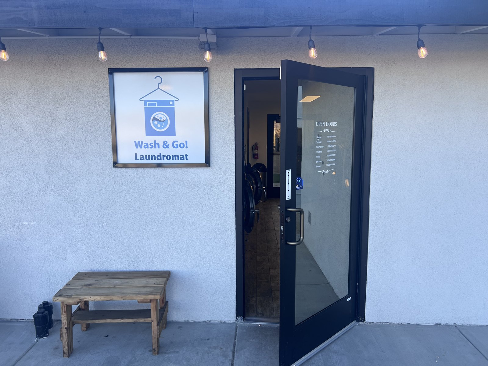 Wash and Go Laundromat entrance and blue sign at Unit C